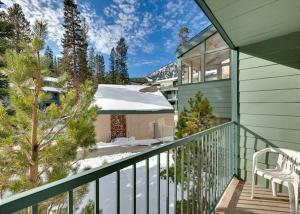 a balcony of a house with a snow covered roof at St Anton Courtyard View Ski-In and Out 1 Bedroom Condo in Mammoth Lakes