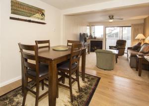 a living room with a table and chairs in a room at St Anton Courtyard View Ski-In and Out 1 Bedroom Condo in Mammoth Lakes +16 photos