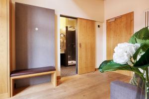 a living room with a couch and a chair at homie hotel wiener botschaft in Veitshöchheim
