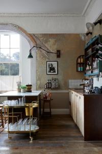a kitchen with a counter and a table with chairs at Artist Residence Bristol in Bristol