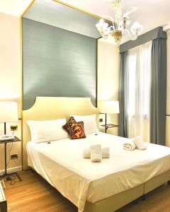 a bedroom with a large bed with two towels on it at Hotel Do Pozzi in Venice