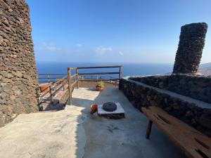 a stairway with a bench and a view of the ocean at Pajero Las Cadenas in Valverde