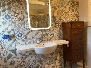 a bathroom with a sink and a mirror at ANTICA VILLA - Guest House & Hammam - Servizi come un Hotel a Cuneo in Cuneo