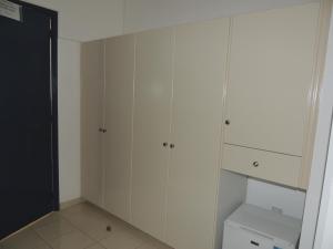 a white closet with white cabinets and a toilet at West End Hotel in Peyia