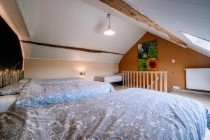 a bedroom with two beds and a large window at A La Maison d'Ode in Sainte-Ode