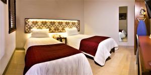 Postel nebo postele na pokoji v ubytování Hotel Caribe Merida Yucatan