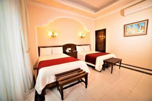 Postel nebo postele na pokoji v ubytování Hotel Caribe Merida Yucatan