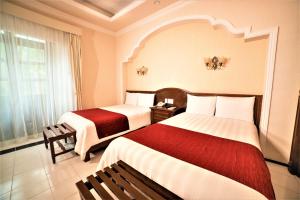 Postel nebo postele na pokoji v ubytování Hotel Caribe Merida Yucatan