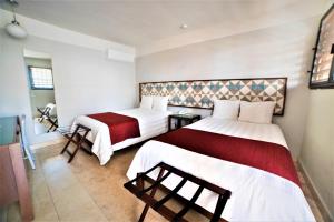 Postel nebo postele na pokoji v ubytování Hotel Caribe Merida Yucatan