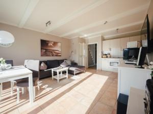 a living room with a couch and a table at Beachcomber House B in Friedrichskoog