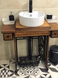 a sink on a wooden table in a bathroom at Tinnins Cottage in Newry