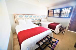 Postel nebo postele na pokoji v ubytování Hotel Caribe Merida Yucatan