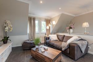 a living room with a couch and a coffee table at Residenz Kubitzer Bodden Rügen in Rambin +76 photos