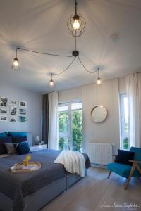 a bedroom with a large bed with a blue blanket at Olszowa 14 by The River Apartment in Warsaw