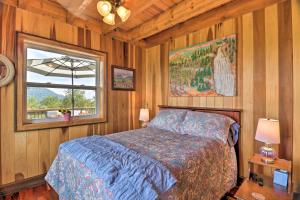 a bedroom with a bed and a window in a room at Stunning Mountain Views Hot Springs Hideaway! in Sandymush