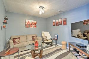 a living room with a couch and a table at Lower-Level Woodbridge Apt with Patio - 32 Mi to DC! in Woodbridge