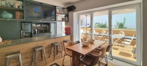 a kitchen with a bar with a table and chairs at Casa BARR in Trafaria