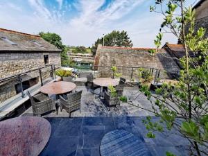 an outdoor patio with tables and chairs and buildings at The Royal Station Hotel in Carnforth