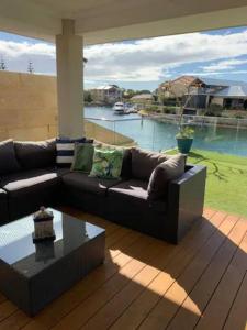 a living room with a couch and a coffee table at Sandpiper Island Tranquil Waterfront Views & Jetty in Wannanup