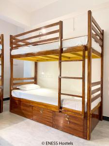 a bunk bed with two bunk beds in a room at Eness Hostels Pondicherry in Puducherry