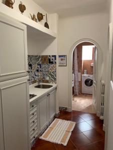 a kitchen with a sink and a laundry room at Casa Nenna, centro di Forio in Ischia