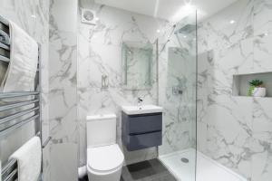 a bathroom with a toilet and a sink and a shower at Minster's Reach York close to York Minster in York +48 photos