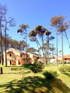 a house with trees in front of it at Pino Dorado in Punta del Este