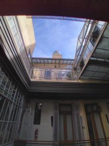 a balcony of a building with a glass ceiling at Parla Hostel in Buenos Aires