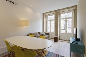 a living room with a white table and chairs at RVA - Clerigos Apartments in Porto