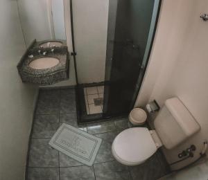 a bathroom with a toilet and a shower and a sink at Hotel Bauer in Torres