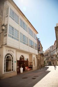 un grand bâtiment avec de nombreuses fenêtres sur une rue dans l'établissement Hotel Eli-Mar, à A Guarda