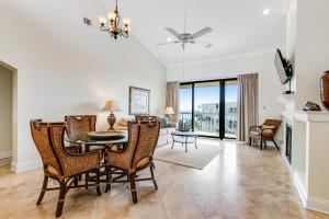 a dining room and living room with a table and chairs at King & Prince Villa 458 in East End