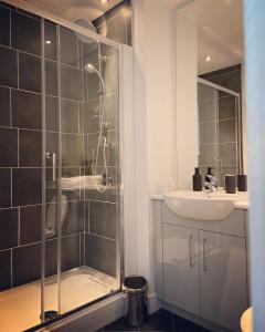a bathroom with a shower and a sink at The Law House By The Opulence - Free City Centre Parking in Bradford