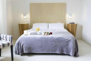 a bed with two candles and two stuffed animals on it at Villa con piscina privada Palmeras Home in Las Palmas de Gran Canaria