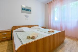 Postel nebo postele na pokoji v ubytování Apartments Anica