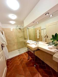 a bathroom with a sink and a shower and a tub at LOCUS Dubrovnik in Dubrovnik