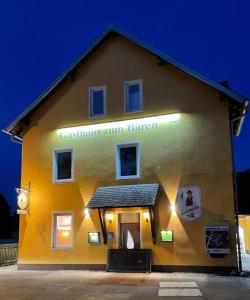 a yellow building with a sign on the side of it at Gasthaus zum Bären in Donauwörth