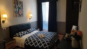 a bedroom with a bed and a lamp at Albergo la Svolta in Brescia