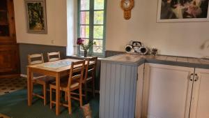 a kitchen with a table and chairs and a clock at Andersson, FA in Fa