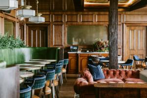 a restaurant with tables and chairs and a couch at Rusacks St Andrews in St. Andrews