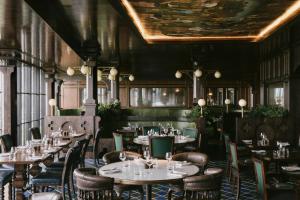 a restaurant with tables and chairs and a ceiling at Rusacks St Andrews in St. Andrews