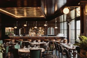 a restaurant with tables and chairs and a bar at Rusacks St Andrews in St. Andrews
