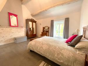 a bedroom with a large bed and a window at Maison De L'Etang in Essey