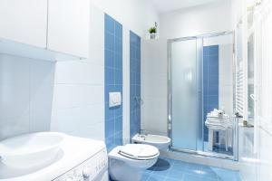 a bathroom with a toilet and a sink and a shower at Luxury Flat in Town - Lucca City Center in Lucca +7 photos