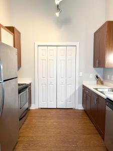 a kitchen with white doors and wooden cabinets at Porsch City Loft in Atlanta