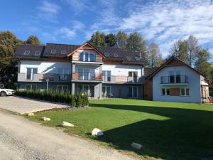 a large house with a lawn in front of it at Apartamenty Antonio 2 in Kudowa-Zdrój