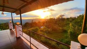 a view of the sunset from the balcony of a house at Dadaji Villa in Panchgani