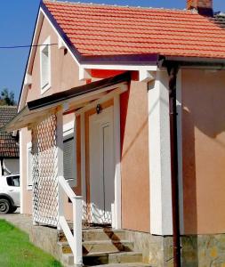 uma pequena casa com um telhado laranja e uma porta em ASTER apartman Bor em Bor