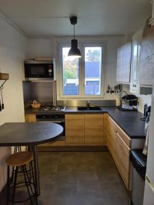a kitchen with a stove top oven and a sink at Private room II in Beauvais