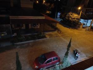 a red car parked in a parking lot at night at Rancho Santiago in Neiva